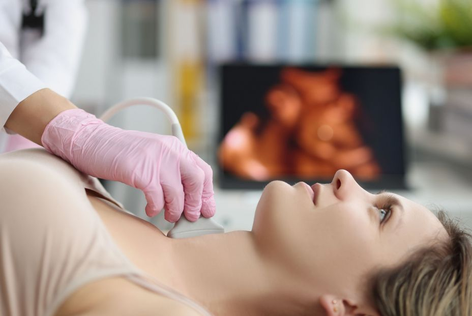 bigstock Doctors Hands On A Womans Neck 449474227