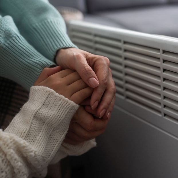 bigstock At The Electric Heater People 464879457 bigstock At The Electric Heater People 464879457