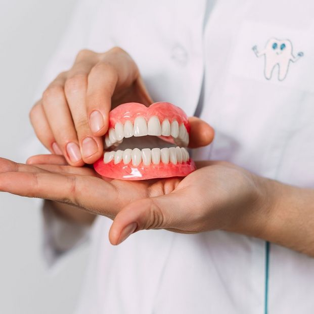 bigstock The Dentist Is Holding Denture 447705508 bigstock The Dentist Is Holding Denture 447705508