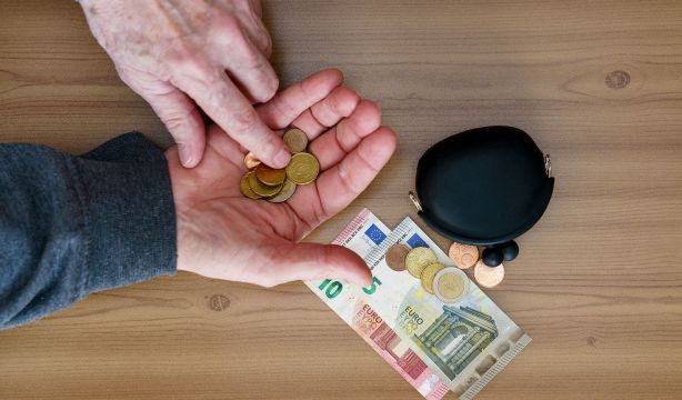 bigstock Hands Counting Small Coins Th 416165404