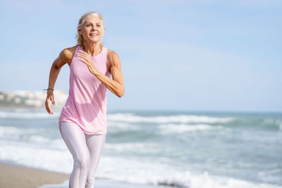 bigstock Mature Woman Running Along The 450846563