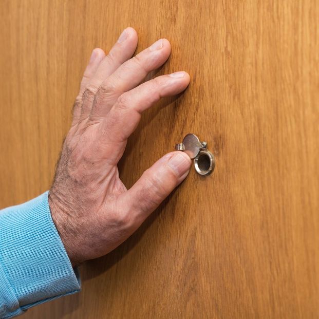 bigstock Senior Man Hand Open The Peeph 292139368