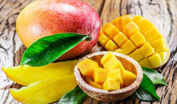 bigstock Mango fruit and mango cubes on 122875289