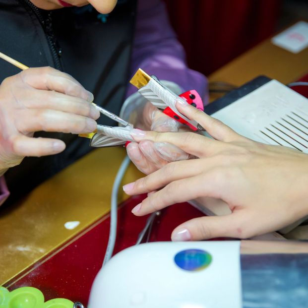 bigstock Woman In A Nail Salon Receivin 369967966