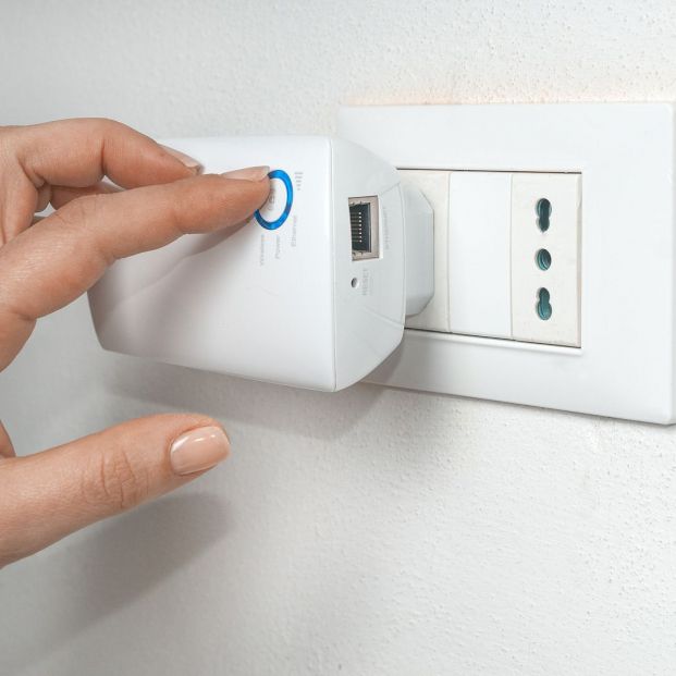 bigstock Woman Turn On A Wifi Repeater361730791