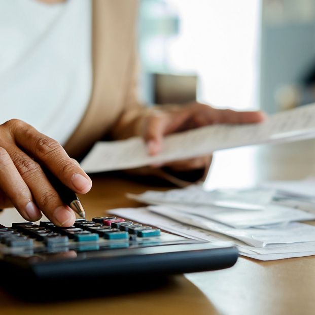 bigstock Woman With Bills And Calculato 265210486 bigstock Woman With Bills And Calculato 265210486