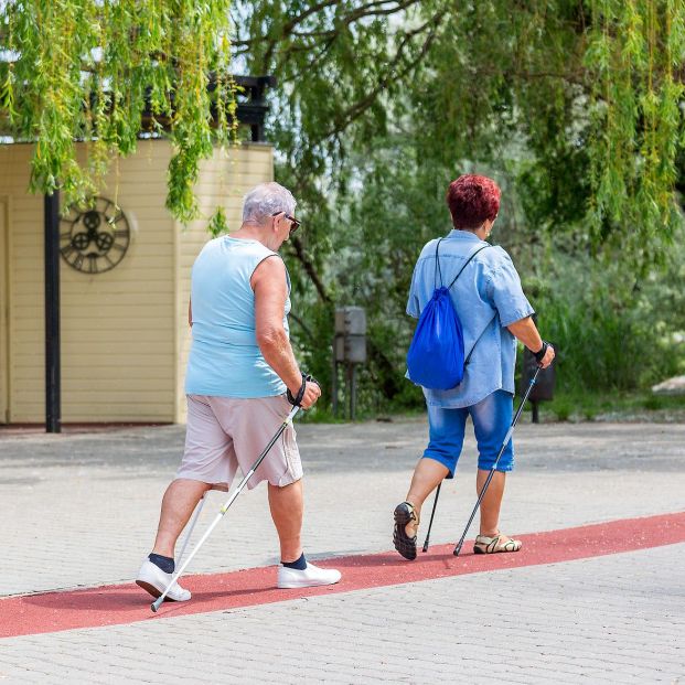 bigstock Senior Couple Walking With Hik 310972705