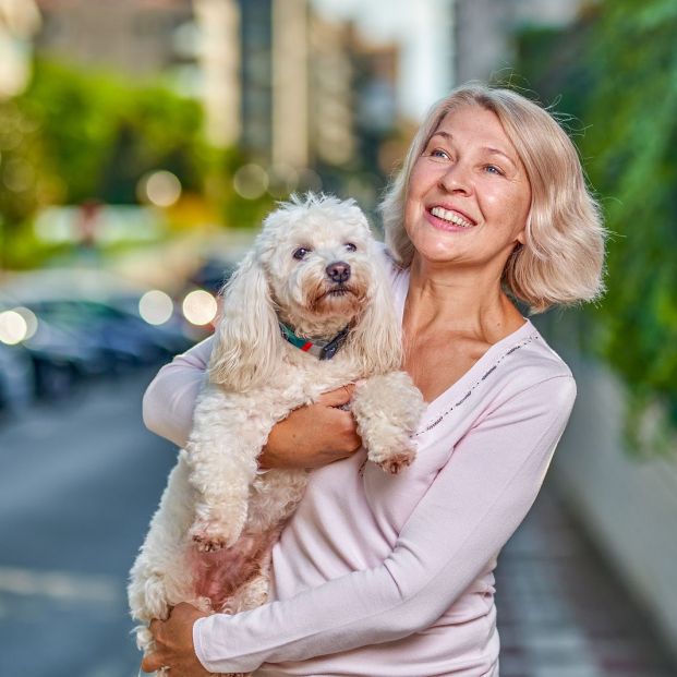 bigstock Happy Woman With A Dog In Her384158096