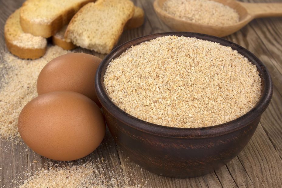 bigstock Bowl With Bread Crumbs On Wood 380627590