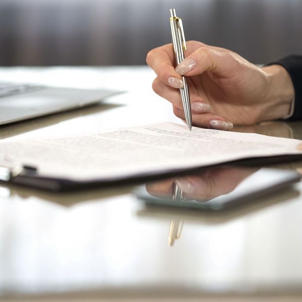 bigstock Woman In Suit Reading Terms An 347286031