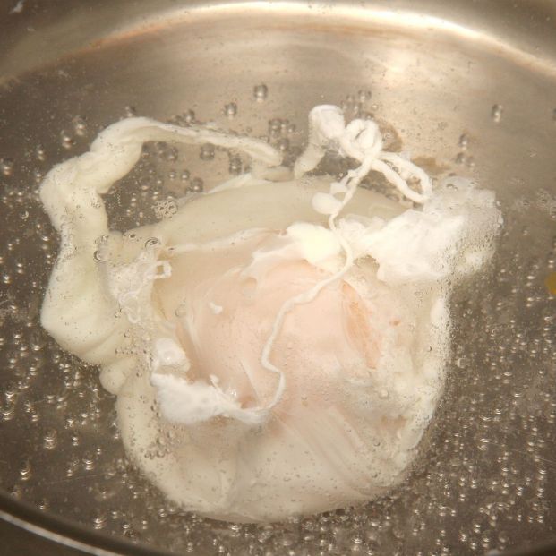 bigstock An Egg Poaching In A Pan Of Bo 369679975